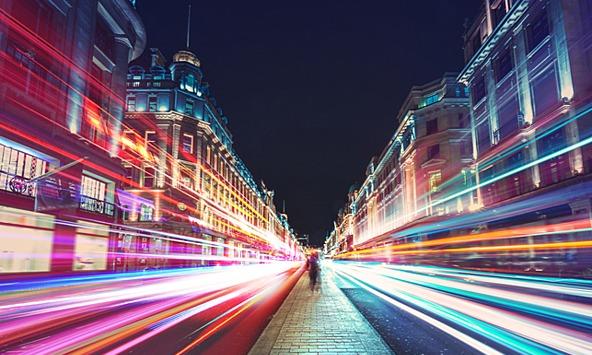 London street at night with long exposure light trails from traffic